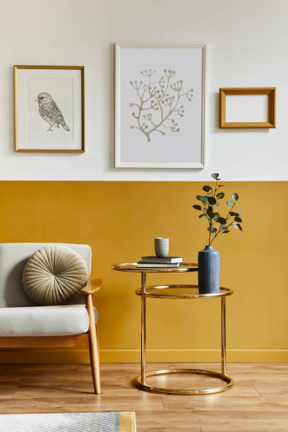 istock Unique living room in modern style interior with design sofa, elegant gold coffee table, mock up poster frames, flowers in vase, decoration and pesronal accessories in home decor. Template. 1288636020