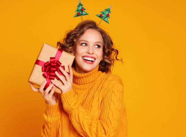istock Glad young female with Christmas gift 1288636203