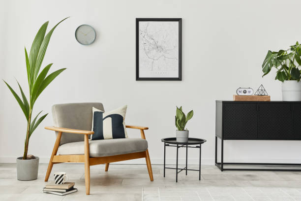 istock Modern retro concept of home interior with design grey armchair, coffee table, commode, plants, mock up poster map, carpet and personal accessoreis. Stylish home decor of living room. 1288636287