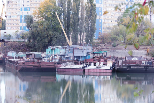 istock KRASNODAR, RUSSIA - OCTOBER, 2020: Old rusty barge and tug. a few rusty barges 1288636549