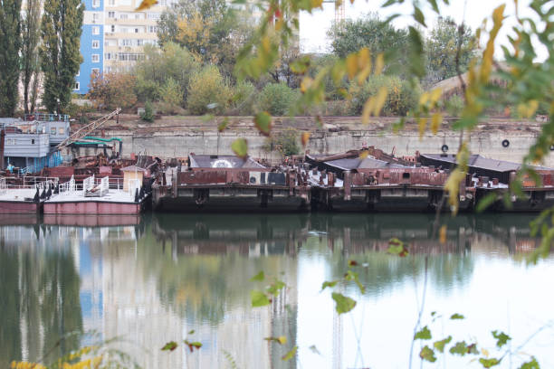 istock KRASNODAR, RUSSIA - OCTOBER, 2020: Old rusty barge and tug. a few rusty barges 1288636551