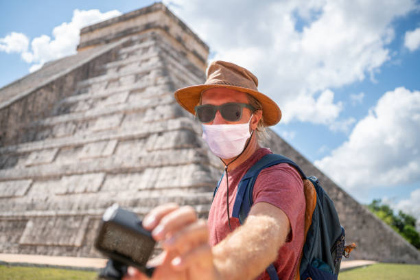 istock Man takes selfie in Mexico, he wears face mask 1288637632