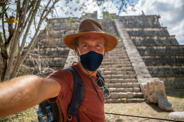 istock Man takes selfie in Mexico, he wears face mask 1288637763