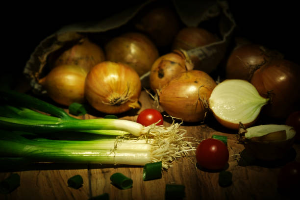 Fresh spring onions on a wooden board
