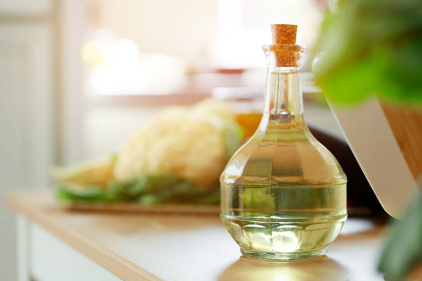 istock Glass bottle of oil on kitchen counter 1288638272