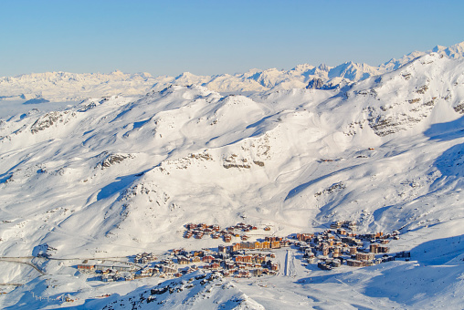 View on the Val Thorens ski resort in the French Alps from high above during a beautiful winter day during the skiing season.