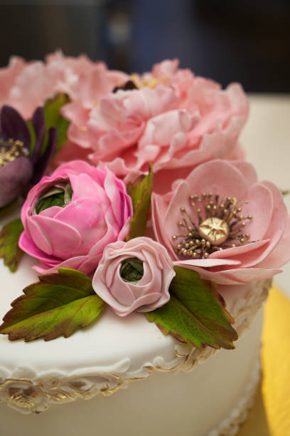 istock White cake with pink flowers on golden tray 1288640054