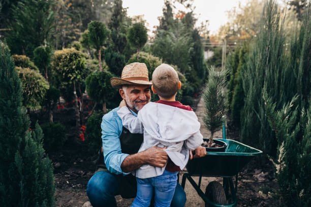 istock boy with his grandfather in plant nursery 1288641020