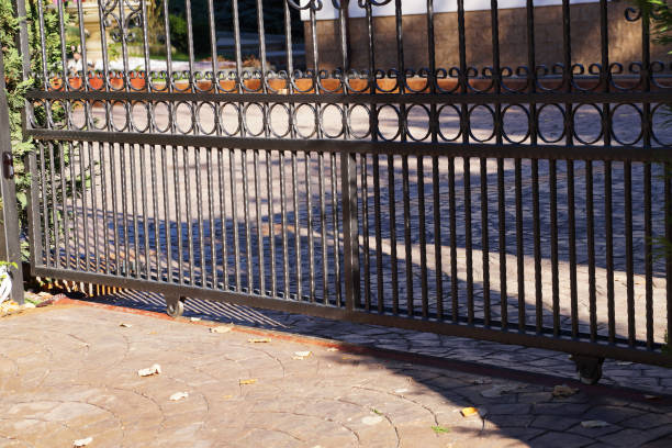istock metal forged sliding gate on rollers close up 1288641572