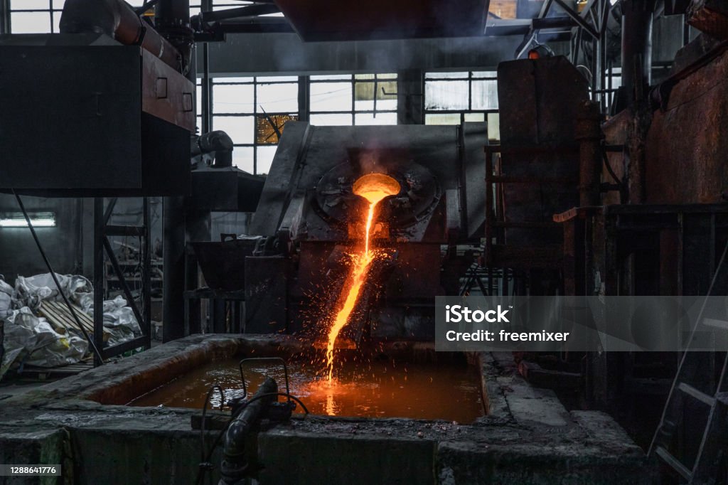 Industrial copper casting in factory Industrial copper casting in factory, molten copper  flowing into water for cooling Copper Stock Photo