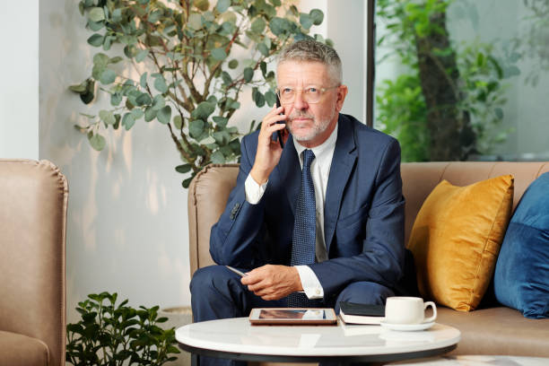 istock Pensive entrepreneur talking on phone 1288642361