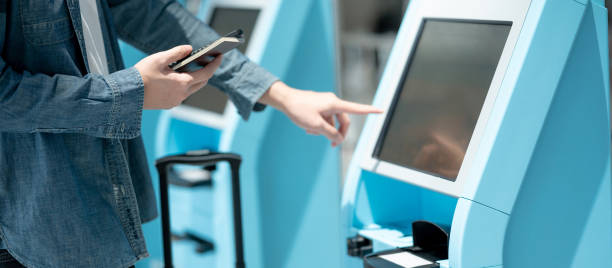 istock Male tourist using self check-in kiosk in airport 1288643359