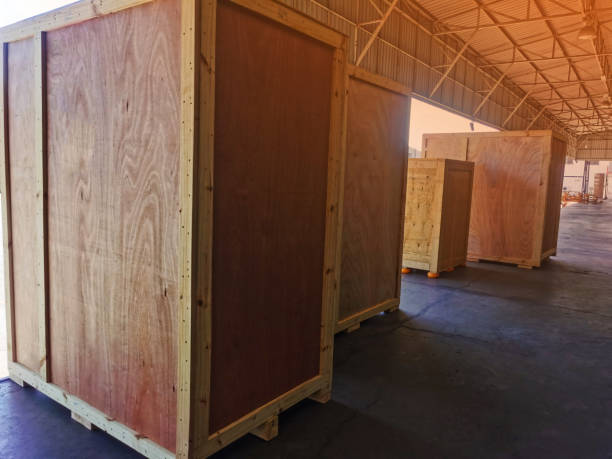 istock Worker driving forklift loading shipment carton boxes goods on wooden pallet at loading dock from container truck to warehouse cargo storage in freight logistics, transportation industrial, delivery 1288643376