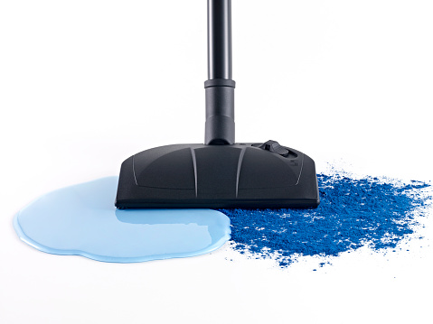 Wet and dry vacuum cleaner vacuuming liquid on white background