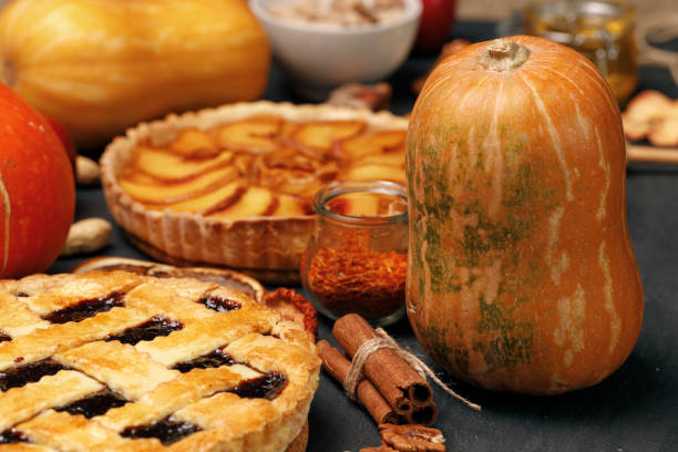 istock Tart pie and pumpkin on dark black surface 1288646802