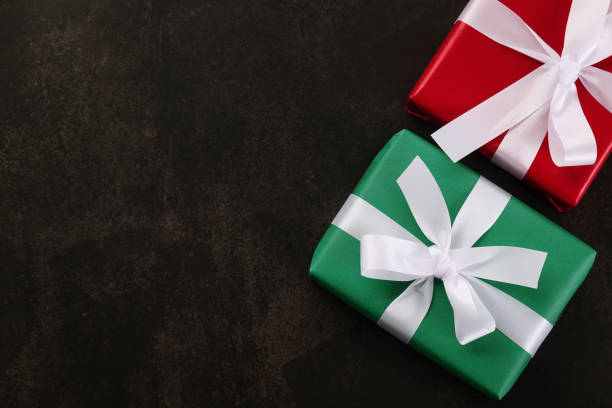 istock Top view of Christmas gift boxes on grunge background 1288646916