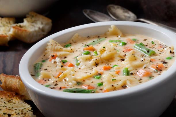 istock Creamy Macaroni and Cheese Soup with Bow Tie Pasta Garlic Bread 1288649514