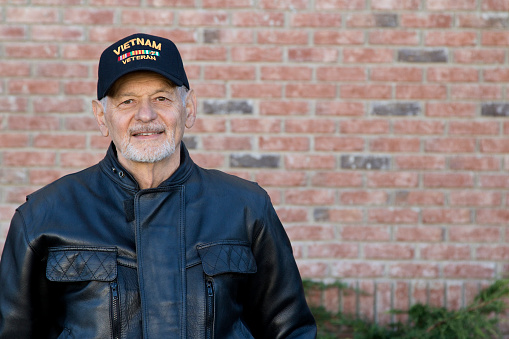 Veteran wearing baseball cap with Vietnam War lettering.