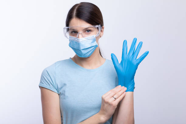 istock Nurse or doctor wearing and checking protective equipment against viruses and bacterial disease 1288652485