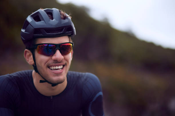Close-up of young cyclist smiling with helmet and sunglasses