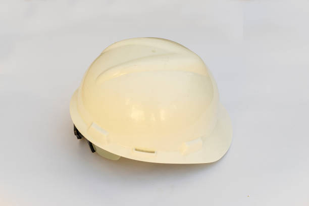 istock Plastic hard white safety helmet on white background. 1288655267