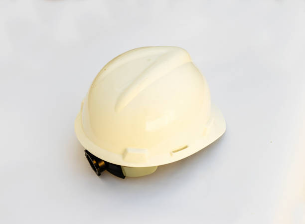 istock Plastic hard white safety helmet on white background. 1288655268