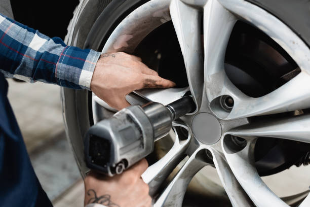 istock partial view of technician fixing wheel on car with pneumatic wrench 1288655514