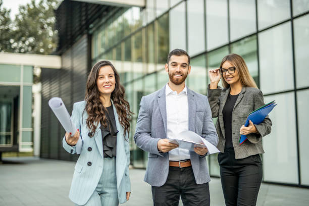 istock Three business people walking and talking about job 1288656538