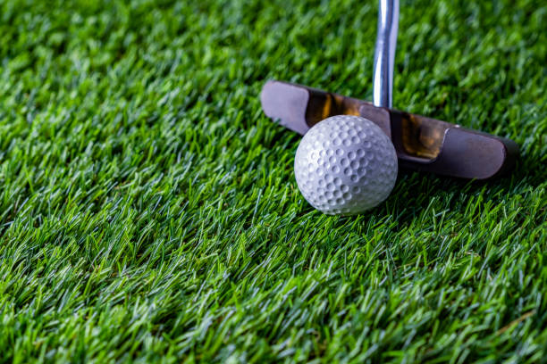 istock Golf ball with putter on green grass 1288657033