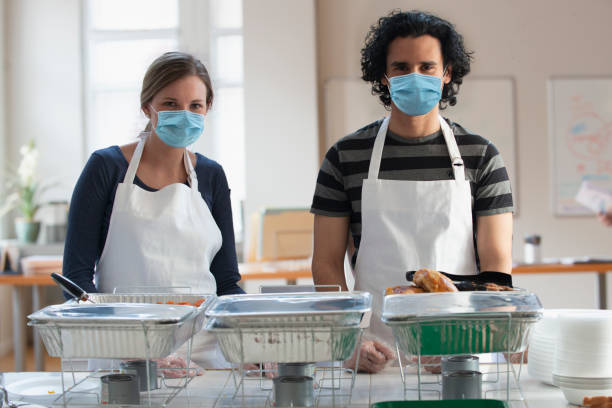 istock Volunteer wearing protective mask in community center 1288658033
