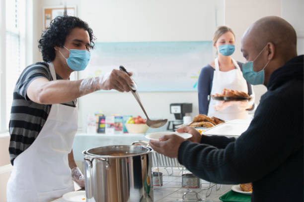 istock Volunteer wearing protective mask in community center 1288658204