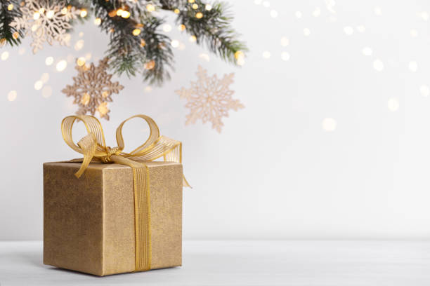 istock Golden gift box and fir tree branch 1288658841