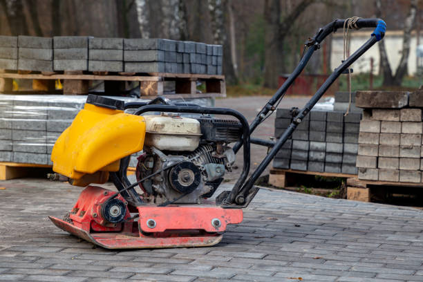 istock Vibrating plate compactor machine at a construction site. Equipment for soil thrombosis. Compaction work on sand, earth or asphalt 1288660141