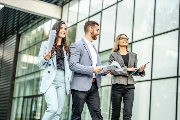 istock Three business people walking and talking about job 1288662614