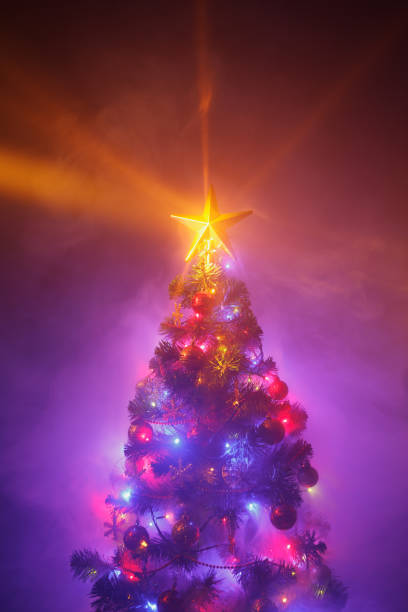istock Christmas tree with shining star and dense smoke 1288663109