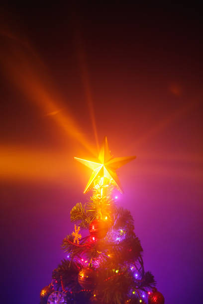 istock Christmas tree with festive lights, purple background 1288663130