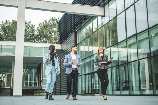 istock Three business people walking and talking about job 1288663284