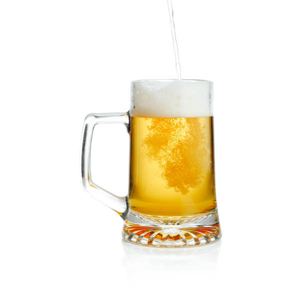 istock pouring a mug with fresh draft beer, isolated on white 1288663289