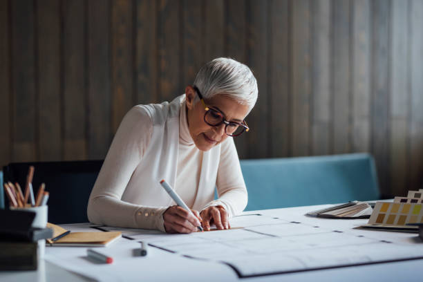 istock Experienced Female Architect Working on a New Project in her Home Studio 1288664630