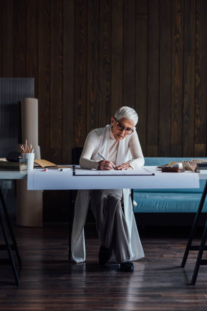 istock Elegant Elderly Designer Making an Outline for her Latest Project (Copy Space) 1288664633