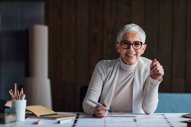 Smiling Senior Civil Engineer Working on a Project in her Office