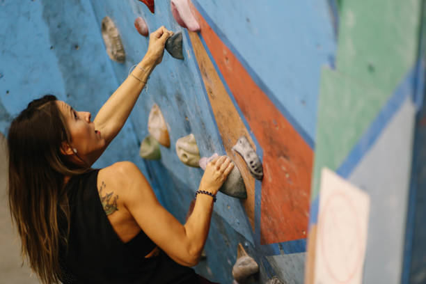 istock Muscular woman training boulder climbing 1288664676