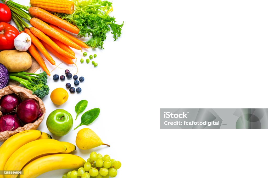 Fresh fruits and vegetables frame on white background. Copy space Food backgrounds: overhead view of healthy fresh organic multicolored fruits and vegetables arranged at the left border of a white background making a frame and leaving useful copy space for text and/or logo at the right. The composition includes carrots, tomato, corn, spinach, green peas, Spanish onion, lettuce, broccoli, radish, cabbage, potato, garlic, banana, green apple, pear, grape, blueberries and peach. High resolution 42Mp outdoors digital capture taken with SONY A7rII and Zeiss Batis 25mm F2.0 lens Vegetable Stock Photo
