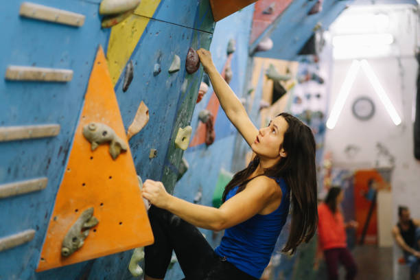 istock Woman doing a boulder climbing training indoors 1288665370