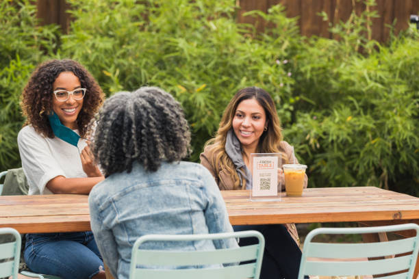 istock Three female colleagues meet at cafe during coronavirus epidemic 1288665586