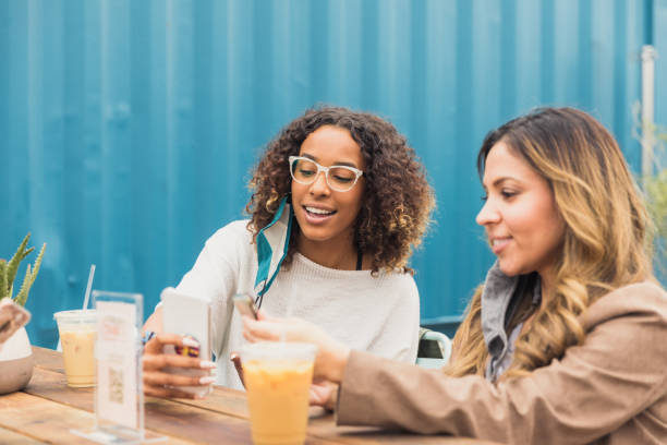 Women download menu in restaurant during COVID-19