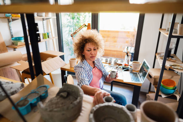 istock Arranging the pots on a shelf by a female potter 1288667003