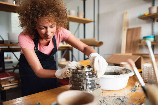 istock Woman working with cement on a new plant pot 1288667062