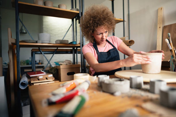 istock Woman making plant pot in her creative studio 1288667086