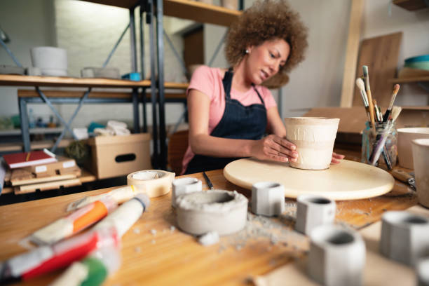 istock Women artisan working in her creative pottery studio on a new concrete pot 1288667093